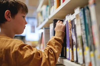 boy picking book