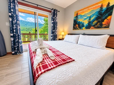 King size bed overlooking the mountains by the main living area