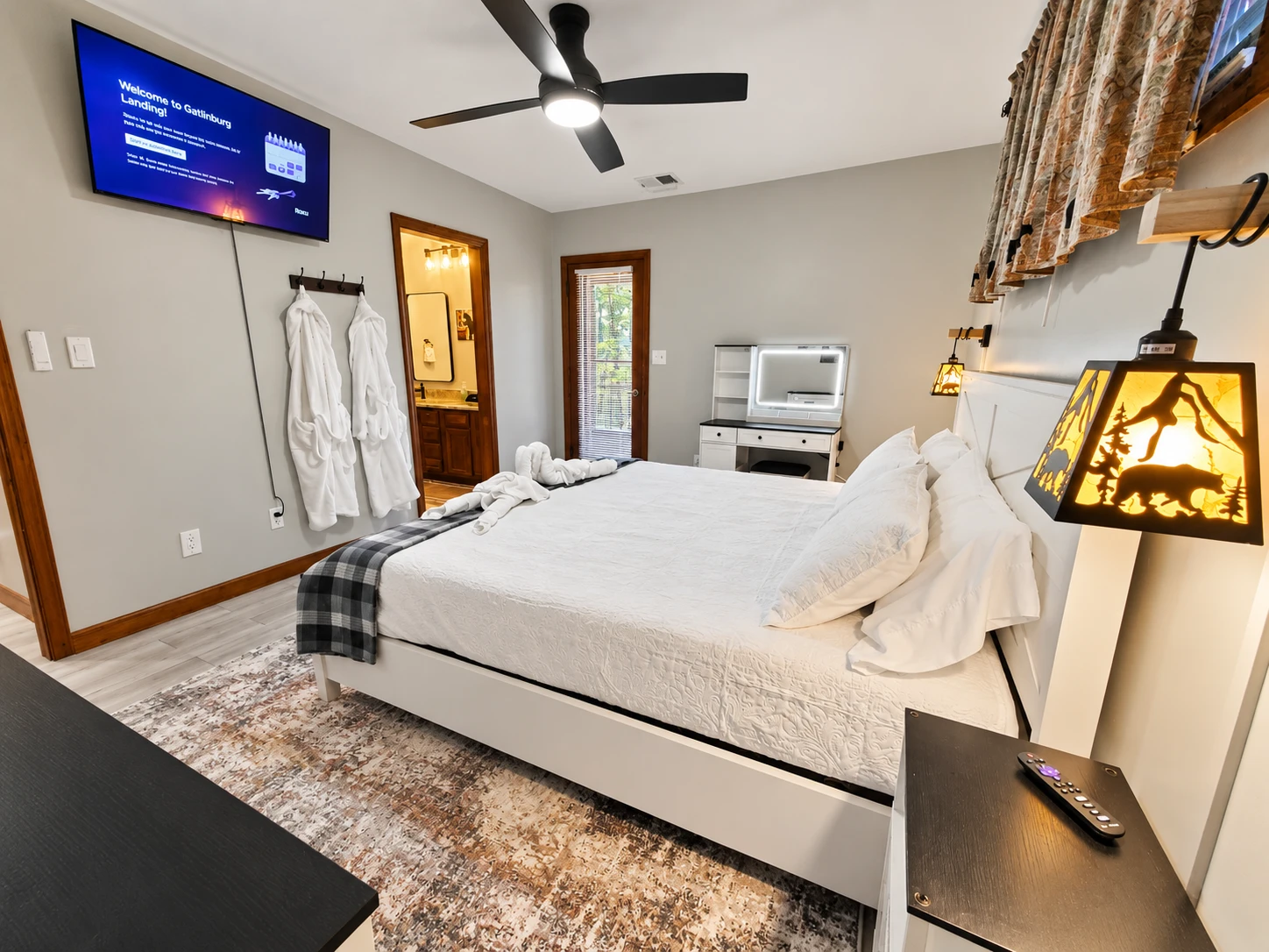 Picture of the master bedroom with 43 inch Smart TV, bath robes, and king size bed