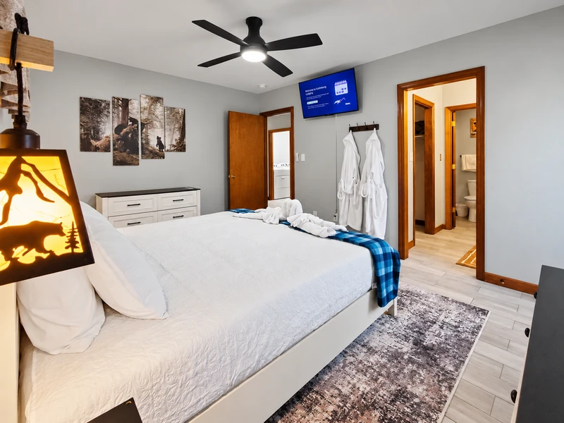 Picture of the master bedroom with 43 inch Smart TV, bath robes, and king size bed