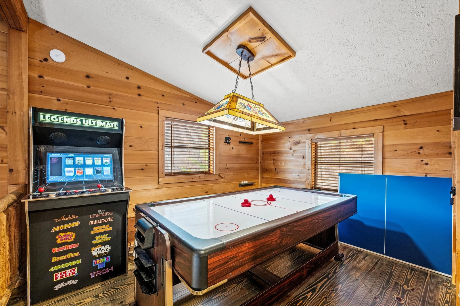 Game room has a multi-cade, ping pong, and air hockey