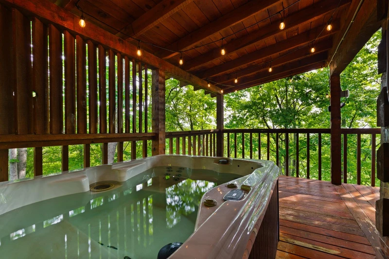 Private hot tub on the covered deck at Nestled Oaks