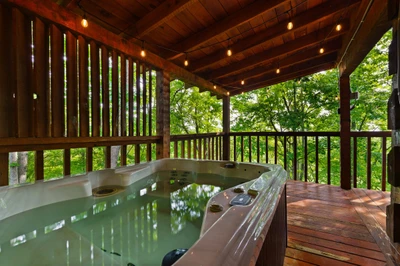 Private hot tub on the covered deck at Nestled Oaks