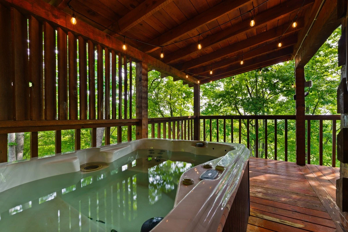 Private hot tub on the covered deck at Nestled Oaks