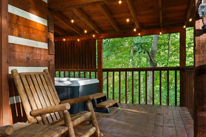 Covered deck with hot tub and string lights