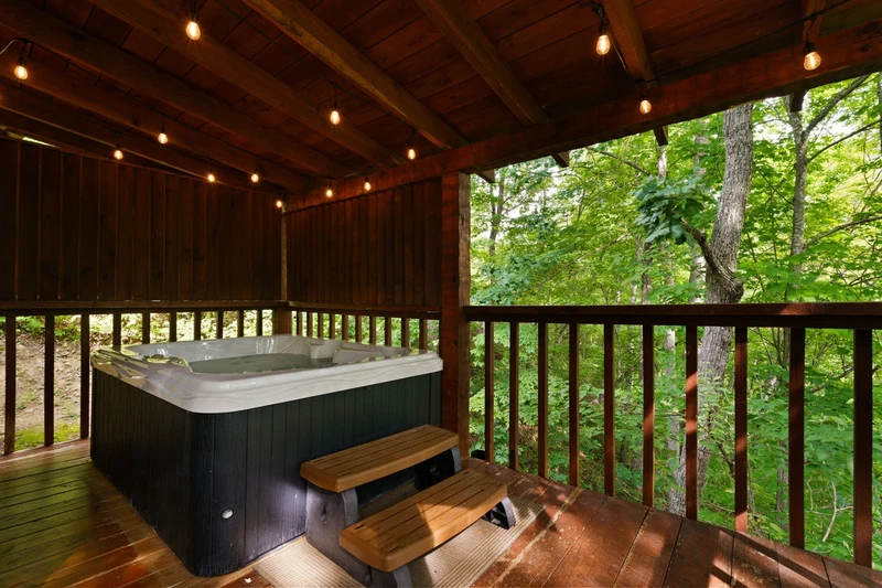 Hot tub surrounded by trees at Nestled Oaks