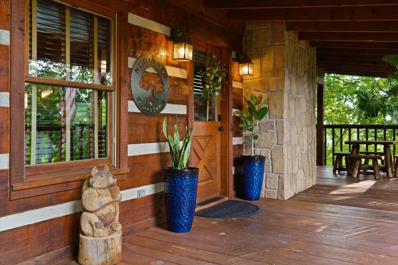Front door of Nestled Oaks with potted plants