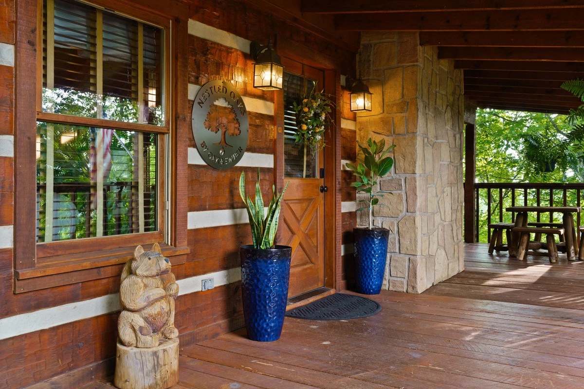 Front door of Nestled Oaks with potted plants