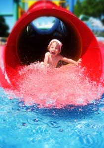 Little girl coming down the water slide