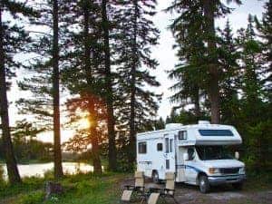 RV and chairs at secluded campsite at sunset