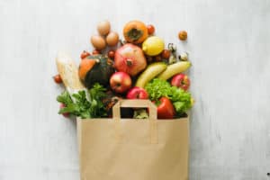 fruits and veggies spilling out of a bag