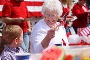 Grandma waving American flag at parade