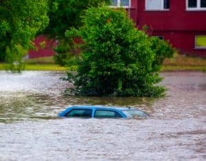Car submerged under water in flood