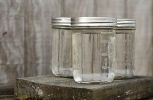 Three clear moonshine jars
