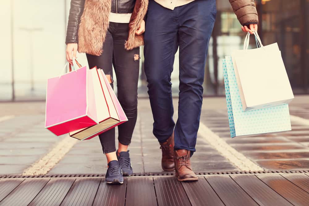 couple walking together with shopping bags