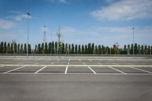 Empty parking lot with trees in the background