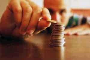 Man stacking and counting coins on the table