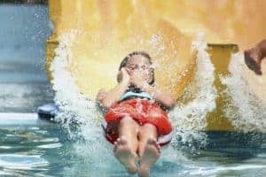 Girl sliding down water slide