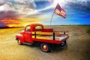 Red pickup truck with American flag