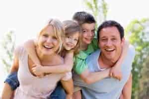 family laughing and playing outdoors