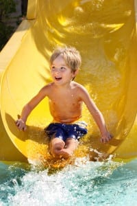 Boy riding water slide at water park
