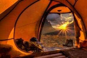 camping in a tent at sunset