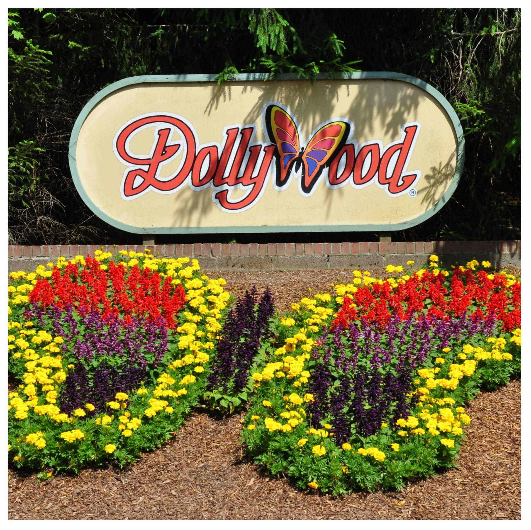 Dollywood sign with butterfly made of flowers at entrance to park