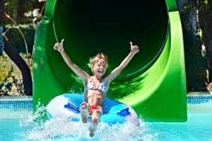 Girl on water slide giving a thumbs up