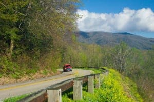 Red vehicle driving on Newfound Gap Road