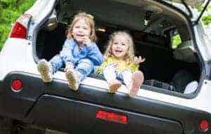 two little kids in the back of a car