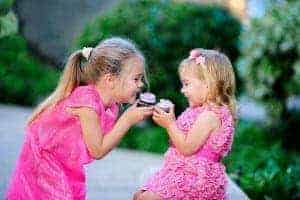 Two girls excited about eating their cupcakes