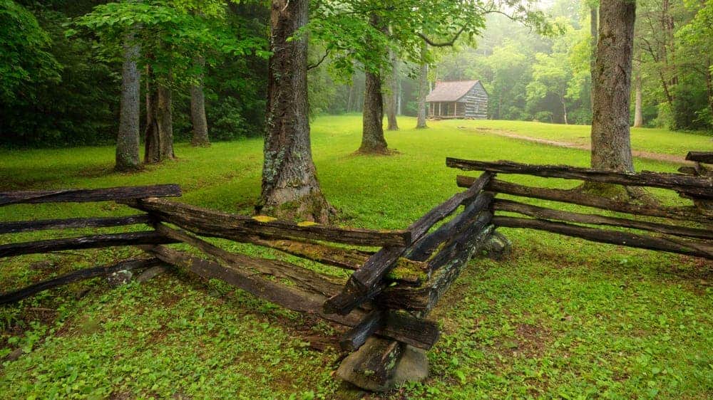 View from behind fence facing cabin in Cades Cove