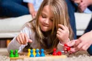 little girl playing boar games inside Gatlinburg cabin