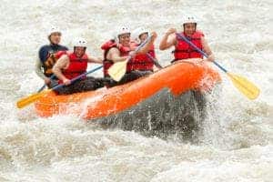 group of people white water rafting