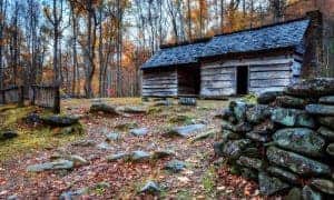 Old cabin covered in fall leaves in the Smoky Mountains