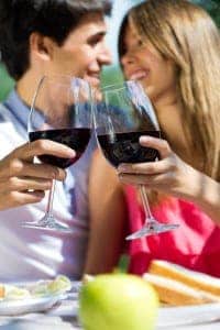 Couple drinking dark red wine and laughing together