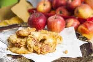 Apple fritters with apples in the background