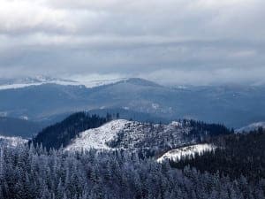 View of the Smoky Mountains as the sun is shining from behind the peaks