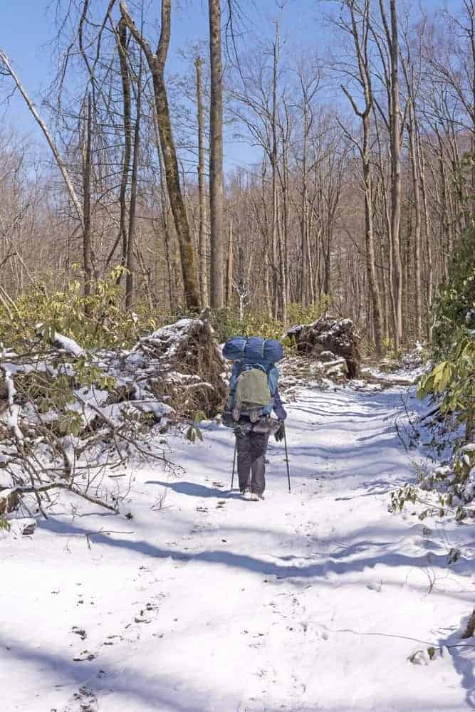 Hiker on a snow covered trail in the Smokies