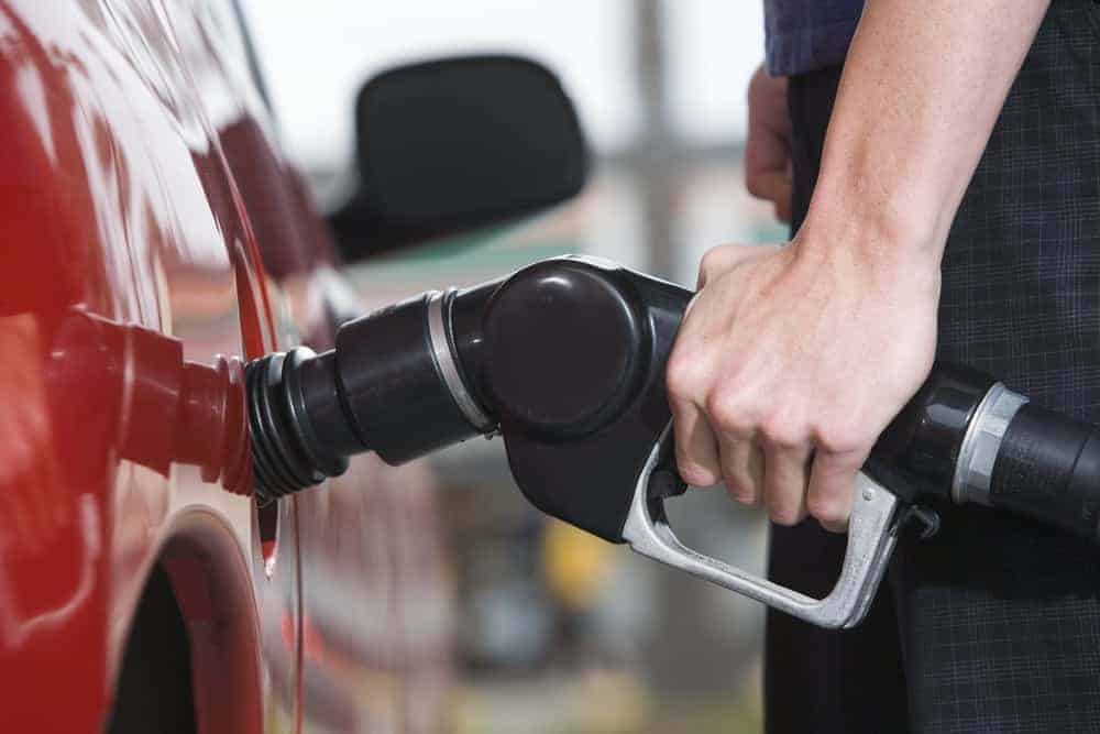 A man filling up a car with gas.