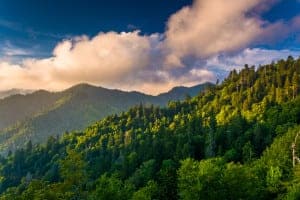 View of the Smoky Mountains as the sun is shining from behind the peaks