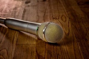 Microphone laying on a brown wooden table
