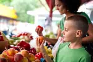 Boy and his mother shopping for produce at the Gatlinburg Farmers Market