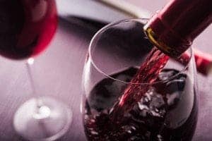 Pouring red wine into a wine glass