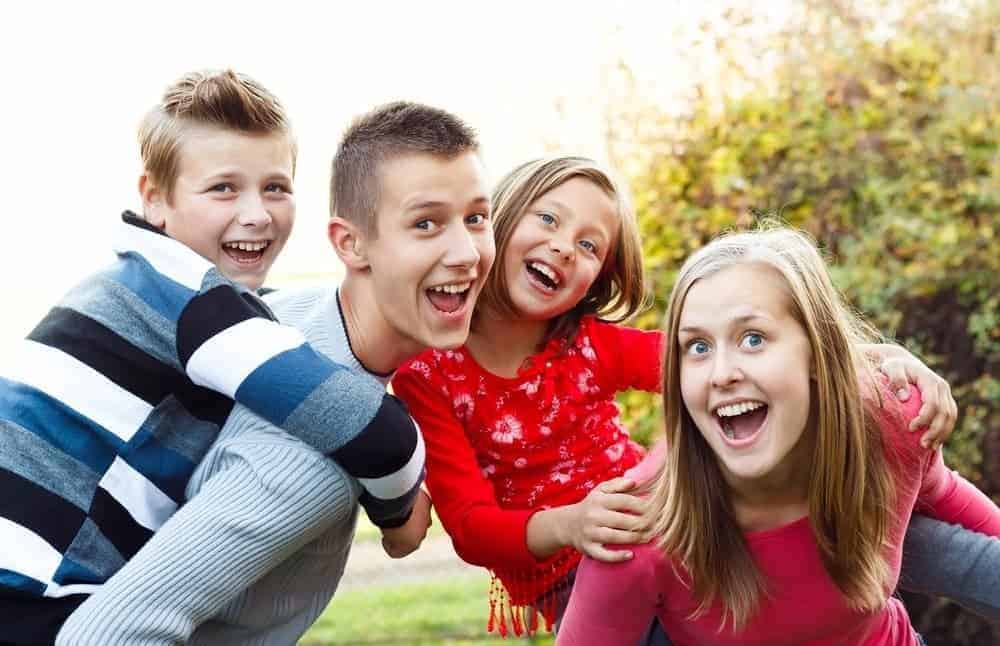 Four kids having fun playing outside together