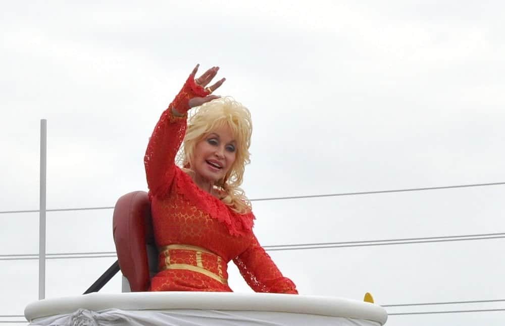 Dolly Parton waving at the crowds during her annual parade in Pigeon Forge.