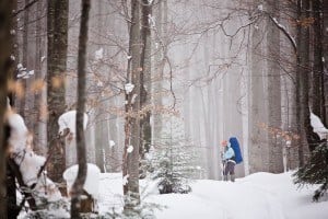 A photo of someone hiking in a winter forest.
