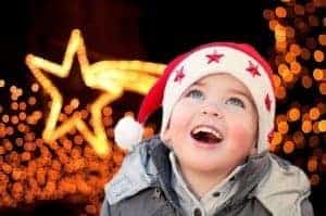 Little boy smiling at Christmas lights