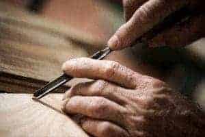Hands doing woodworking.