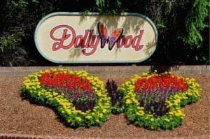 The Dollywood sign and butterfly flower arrangement at the theme park's entrance.